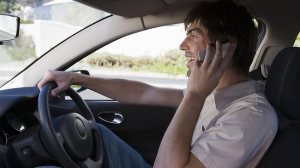 335799-man-driving-while-on-phone